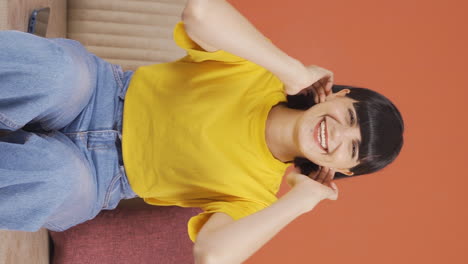 Vertical-video-of-Young-woman-smiling-at-camera